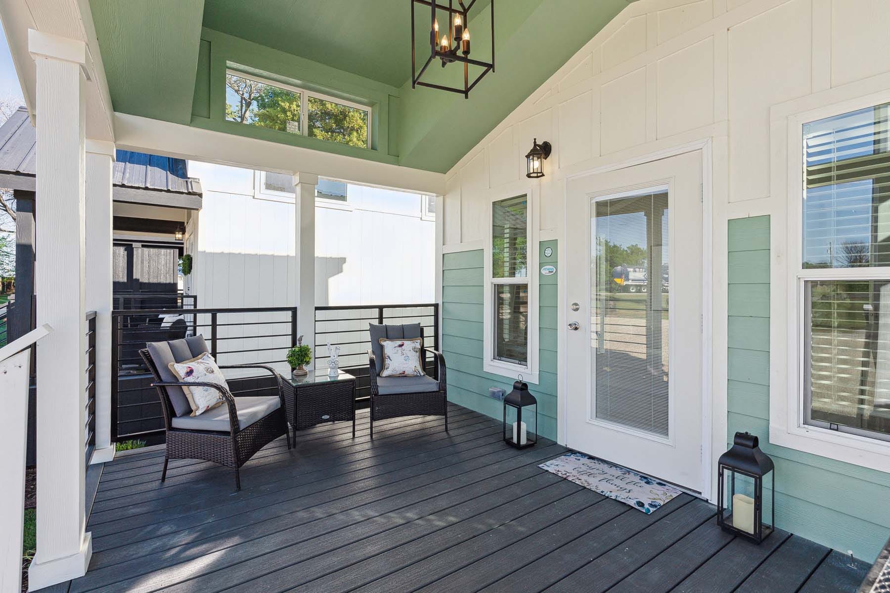 Athens Park model cabin porch with seating and lantern lighting